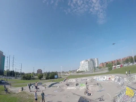 BMX back flip in concrete park aerial follow cam Stock Footage 80615814