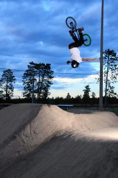 Bmx backflip no hander over dirt jump Stock Photos