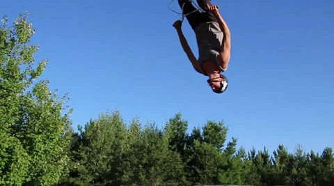 Bmx backflips huge jump in regular speed and slow motion Stock Footage 27692510