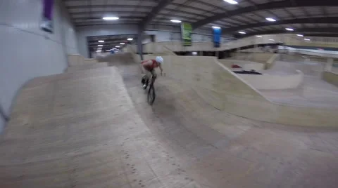 Bmx biker on cool indoor track Stock Footage 49972052