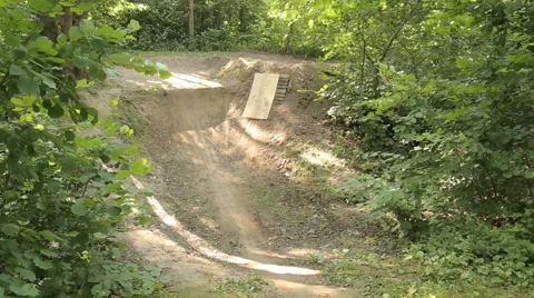 Bmx biker riding in forest Stock Footage 65304280
