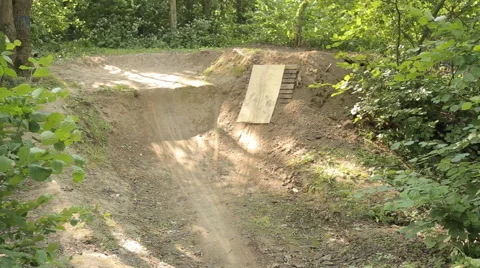 Bmx biker riding in forest Stock Footage 65304501