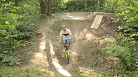Bmx biker riding in forest Stock Footage 65305155