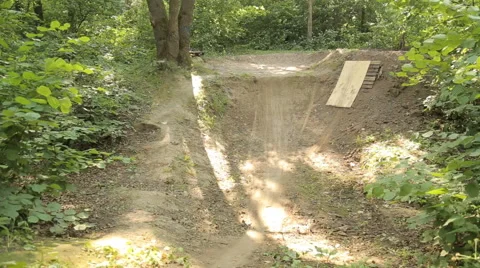 Bmx biker riding in forest Stock Footage 65305570