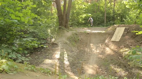 Bmx biker riding in forest Stock Footage 65306457