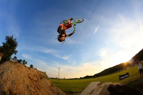 Bmx guy with dreadlocks does backflip over big jump Stock Photos