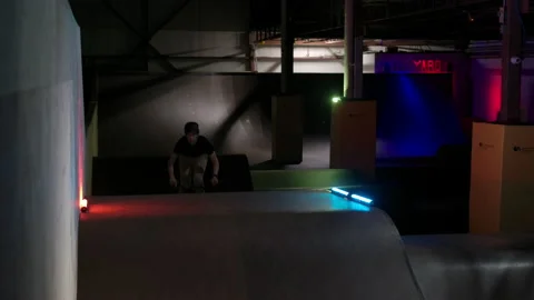 BMX no footed can can trick over a box jump dynamic lights Stock Footage 139948087