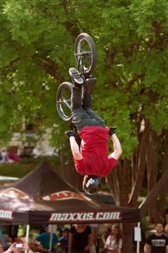 BMX Pro Gets Upside Down Performing Trick In Competition Stock Photos