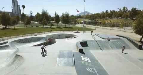 BMX RIDER BIKER DOING TRICKS AND FLIPS IN SKATE PARK AERIAL SHOT 4K Stock Footage 102379360