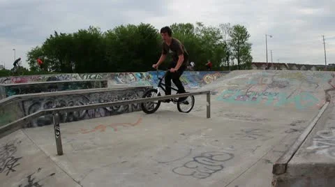 Bmx rider does a 180 to backwards grind to 180 out Stock Footage 8959299
