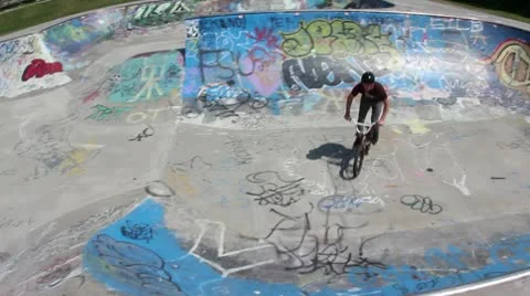 Bmx rider does a 270 barspin with a neat front wheel slide Stock Footage 8960022