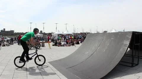 Bmx rider does a 360 barspin landing backwards Stock Footage 8959329