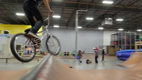 BMX rider does 360 at skate park Video stock 72904669