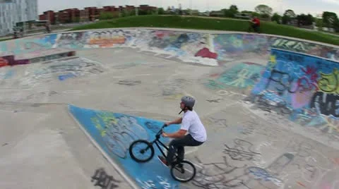 Bmx rider does a 720 over a hip jump Stock Footage 8960231