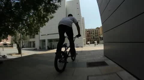 Bmx rider does a big tailwhip down a stair set Stock Footage 8959257