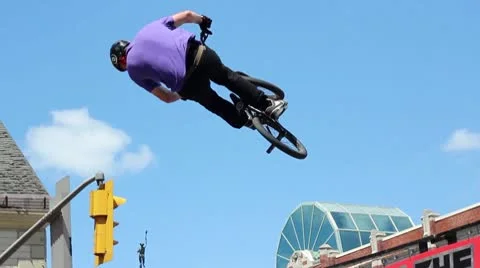 Bmx rider does a huge double tailwhip over a jump Stock Footage 8960031