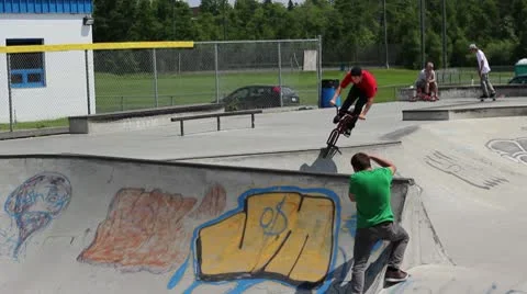 Bmx rider does a no hander over a skatepark spine Stock Footage 8960210