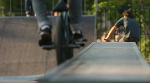 BMX rider does various tricks while riding in skatepark Stock Footage 65216671