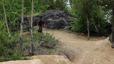 Bmx rider doing a neat set of tricks at the dirt trails Stock Footage 8960219