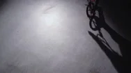 Bmx Rider Doing Tricks In Dark Warehouse. Stock Footage