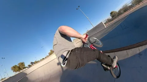BMX rider doing a wall ride on skateboard park ramps Video stock 88448030