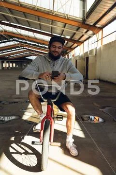 BMX rider in an empty warehouse Stock Photos