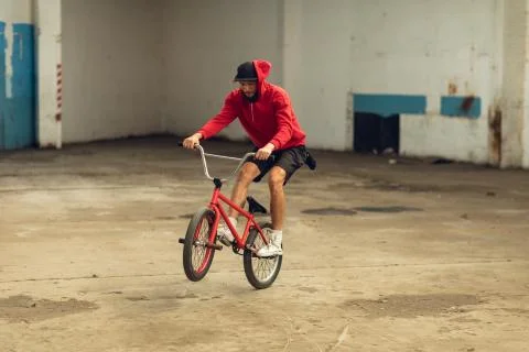 BMX rider in an empty warehouse Stock Photos