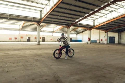 BMX rider in an empty warehouse Stock Photos