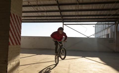 BMX rider in an empty warehouse Фото