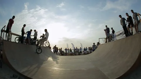 Bmx Rider Falls while performing a stunt on a bike. Bmx-vert on a sunny day Stock Footage 60704422