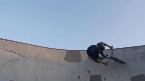 A bmx rider performs a wall ride trick at skate park in slow motion Video stock 120543736
