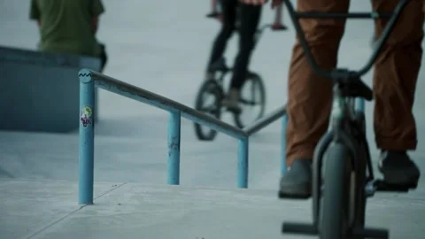 BMX riders are performing tricks. Cyclists in the skatepark. Bicycle sport. Stock-Footage 165740633