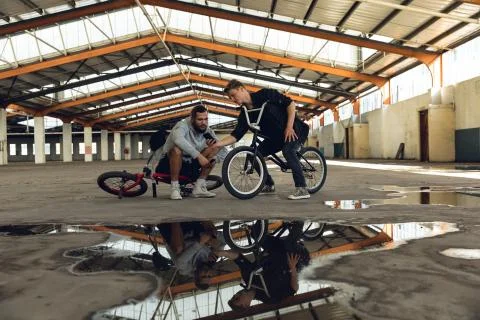 BMX riders in an empty warehouse 스톡 사진