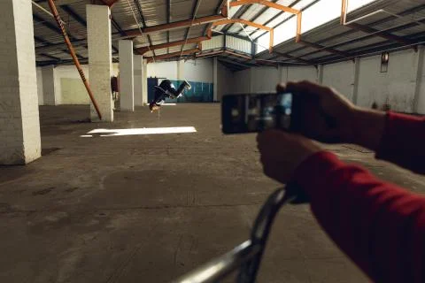 BMX riders in an empty warehouse Stockfoto's