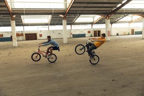 BMX riders in an empty warehouse Stockfoto's