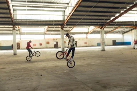 BMX riders in an empty warehouse Stockfoto's