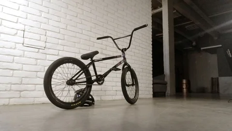Bmx stands at the white brick wall in the building Stock-Footage 103247654