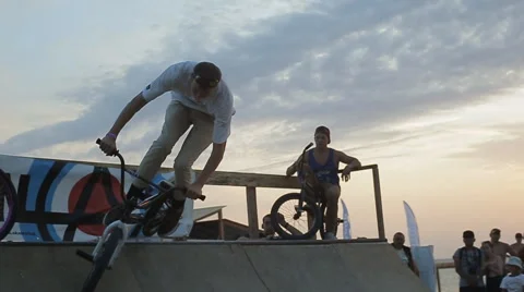 Bmx Stunts at Sunset. Slow Motion of professional Bmx Rider during his Stock Footage 60681171