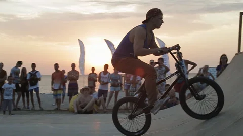 Bmx Stunts at Sunset. Slow Motion of professional Bmx Rider during his Stock Footage 60704452
