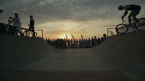 Bmx-vert in Slow Motion. athlete makes turns and jumps on a Bmx bike in the Stock Footage 60680744