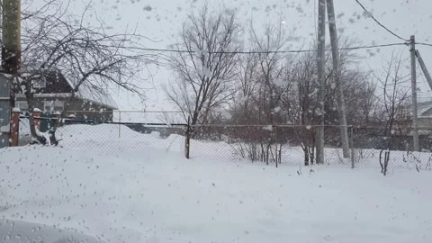 Bnormal snowfall, view from the window of a country house Stock Footage 201535058