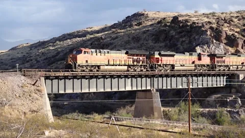 BNSF Freight Train going over a bridge through Arizona mountains Video stock 144902232
