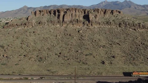A BNSF Railway train passing by a scenic canyon mountain ridge in Kingman AZ    Stock Footage 80626158