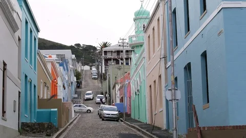 Bo Kaap Cape Town - steep cobbled street with Taxi & residents Stock Footage