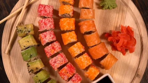 Board of assorted fresh sushi rolls and smartphone Stock Footage 96337224