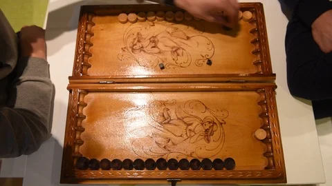 Board of backgammon and hands of two players Stock Footage 120111548