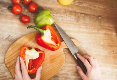 On the board cut the pepper in half Stock Photos