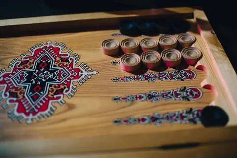 Board for gambling at backgammon with patterns and wooden checkers Stock Photos
