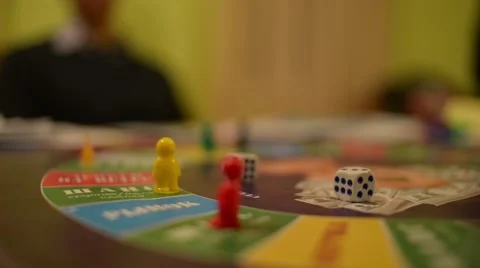 Board Game Cash Flow - a player throws the dice on the field and makes his move Stock Footage 58554447