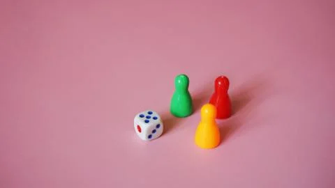 Board game figures and one dice Stock Photos